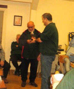 Nick Caruana being presented with the orchard trophy by Paul Hunt